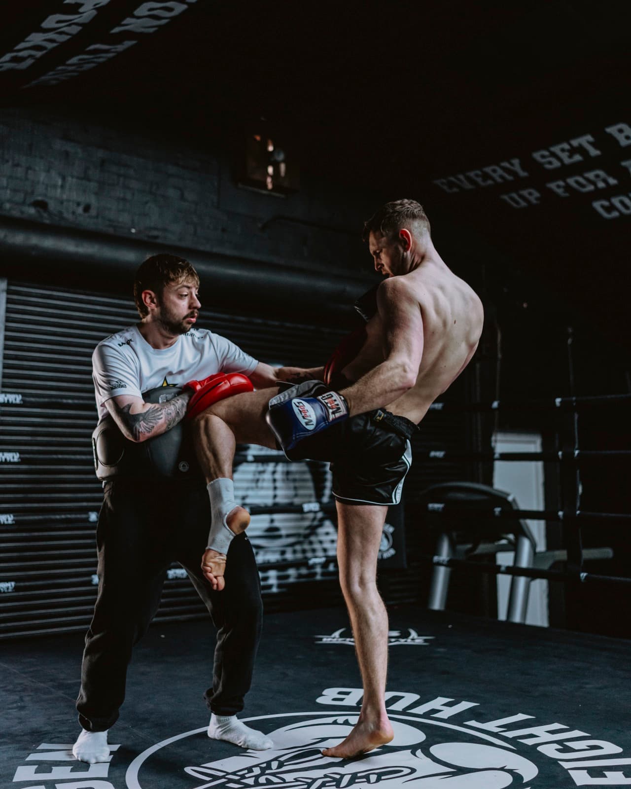 Hayden coaching a fighter through kicks on the pads